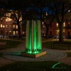 Freestanding illuminated green stand with integrated lighting for urban public spaces at night